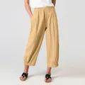 Detailed view of women's loose cotton linen wide-leg cropped pants in light beige color - Earthy Yellow