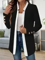 Detail view of stylish black and white color-block blazer with elegant gold sleeve buttons - S / Tops / Black