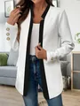 Close-up detail of white textured blazer with black trim and gold buttons - S / Tops / White