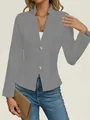 Detail view of a grey textured slim fit blazer with decorative metallic buttons on a model - S / Tops / Gray