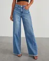 Close-up detail of wide-leg blue jeans with raw frayed hem and side seam stitching - S / Denim Blue