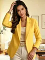 Detailed view of a stylish yellow blazer featuring structured lapels and gold buttons - Yellow