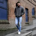 Close-up view of men's distressed light blue skinny jeans with knee rip details - S / Bottoms / Light Blue