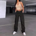 Fashionable model wearing black high-waisted cargo pants in an urban parking lot - S / Bottoms / Black With Black Stitching