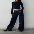 Model wearing retro low-waist wide-leg denim jeans in a vintage street style outfit. - XS / Bottoms / Black (331)