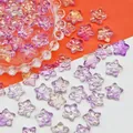 Close-up of iridescent star-shaped glass beads with bow design for DIY jewelry making. - 14x14x8mm / Iridescent Purple (L680)