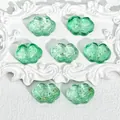 Detailed macro shot of green Ruyi cloud-shaped glass beads with gold foil for jewelry - Liuli Auspicious Cloud (L563) / Gold Green