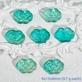 Detailed view of teal glass cloud-shaped pendants with golden shimmer for DIY jewelry - Liuli Auspicious Cloud (L564) / Emerald Green