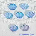 Detailed view of translucent blue and purple cloud-shaped beads with engraved patterns - Liuli Auspicious Cloud (L568) / Purple Blue