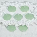 Macro detail of pale green Ruyi cloud-shaped glass beads for DIY jewelry accessories - Liuli Auspicious Cloud (L575) / Jade Color