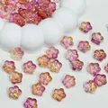 Close-up detail of gradient purple and pink Sakura flower glass beads for DIY jewelry making - Purple Gold