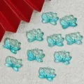 Close-up macro view of light blue lotus-shaped glass beads for DIY jewelry craft making - Double Hole Lotus / Cyan Blue (L860)