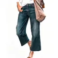 Close-up detail of retro loose whiskered denim cropped jeans worn by a model in casual style - S / Bottoms / Vintage Blue