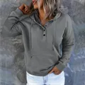 Detail of women's grey casual hoodie featuring button neck and front pocket - S / Tops / Gray