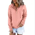 Close-up view of a pink long-sleeved drawstring hoodie with a button neckline detail - Pink