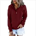 Close-up of a maroon women's long-sleeved hooded sweatshirt with button neckline detail - Burgundy