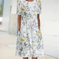 Detail view of white short-sleeve dress with blue and yellow floral print and pockets. - S / Bottoms / Color 3 (Floral Print)