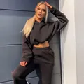 Stylish women's black two-piece tracksuit featuring cropped hoodie and matching joggers. - S / Top And Bottom / Black