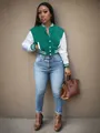 Full-length detail of a green and white color-block varsity jacket for women - Mint Green