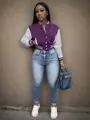 Detail view of a purple and white color-block baseball jacket on a female fashion model - S / Tops / Purple
