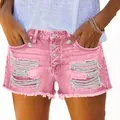 Women's pink ripped denim shorts featuring a fringe hem and stylish button fly - Pink