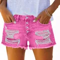 Vibrant hot pink ripped denim shorts featuring button fly and stylish raw fringe hem - Rose Red