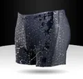 Detail of quick-dry men's boxer swimming trunks showing water droplets and texture. - L / Bottoms / Black