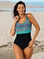 Detail of plus size one-piece swimsuit with ethnic patterns and black bottom on a beach. - M / Top And Bottom / Purple Leopard
