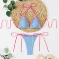 Detail view of light blue textured bikini featuring pink contrast lacing and halter ties. - S / Top And Bottom / Light Blue