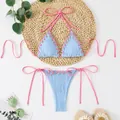 Detail view of light blue textured bikini featuring pink contrast lacing and halter ties. - S / Top And Bottom / Light Blue
