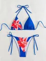 Flat lay of blue two-piece bikini set with vibrant red floral print and side ties - S / Top And Bottom / Red Floral on Dark Blue