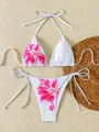 Detailed view of floral print on a white halter bikini set with side-tie bottoms - S / Top And Bottom / Red Floral on White