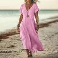 Casual loose pink V-neck cotton linen maxi dress shown on a beach setting - Pink