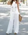 Elegant white halter neck sleeveless top and wide-leg pants two-piece set on a model - S / Top And Bottom / White