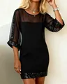 Slim fit black mini dress with sheer mesh sleeves and sparkling sequin trim details. - S / Black