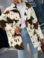 Detailed shot of a cow-print plush jacket with lapel and buttons on a model - S / Tops / Coffee
