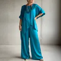 Elegant turquoise satin two-piece set with irregular hem tunic and wide-leg trousers. - Teal