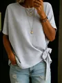 Detail view of a light gray loose T-shirt featuring a stylish side knot at the hem. - S / Tops / Light Gray