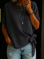 Detail of navy blue short sleeve top featuring a chic side knot hem design - S / Tops / Black