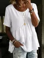 Detailed view of women's white tiered cotton linen tunic top featuring a relaxed round neck. - White