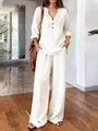 Detail view of a woman wearing a white loose cotton-linen long sleeve set in a bright room - S / Top And Bottom / White