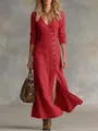 Close-up detail of a red cotton linen long sleeve maxi dress featuring a V-neck and button front - Red