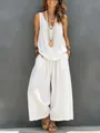 Full-body view of a woman wearing a white casual sleeveless linen tank top and wide-leg pants - White
