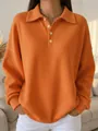 Detailed view of the orange waffle knit fabric and stylish polo collar with buttons - S / Tops / Orange