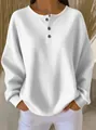 Close-up detail of white waffle knit henley pullover shirt featuring long sleeves and loose fit - S / Tops / White