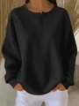 Detailed close-up of black waffle knit texture and three-button Henley neckline detail. - S / Tops / Black