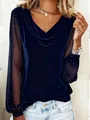 Close-up of elegant navy velvet top featuring sheer mesh sleeves with rhinestone detailing - Dark Blue