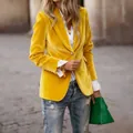 Primer plano de la elegante textura de terciopelo y el vibrante color amarillo del blazer. - S / Tops / Amarillo