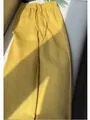 Detailed view of yellow wide-leg trousers with drawstring and textured fabric - S / Bottoms / Yellow