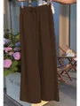 Detailed view of brown wide-leg leisure trousers featuring an elastic drawstring waist - S / Bottoms / Coffee